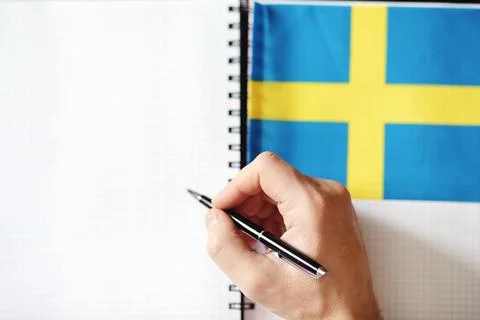 Learning foreign languages. Notepad for entries and a flag. Language course.. Stock Photos