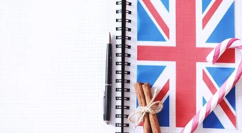 Learning foreign languages. Notepad for entries and a flag. Language course.. Stock Photos