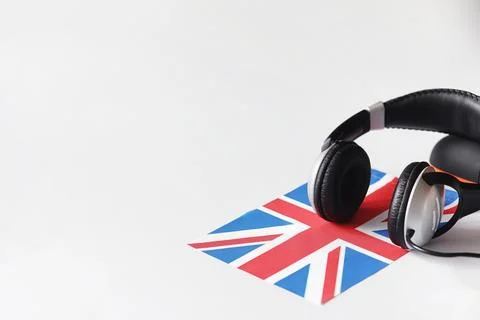 Learning foreign languages. Notepad for entries and a flag. Language course.. Stock Photos