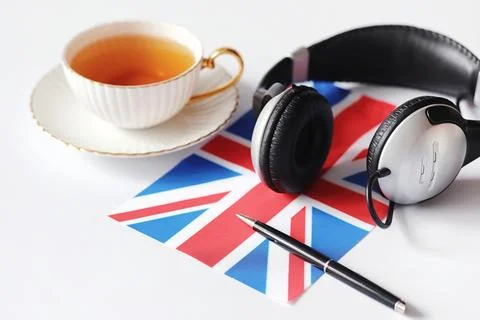 Learning foreign languages. Notepad for entries and a flag. Language course.. Stock Photos
