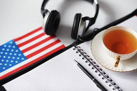 Learning foreign languages. Notepad for entries and a flag. Language course.. Stock Photos