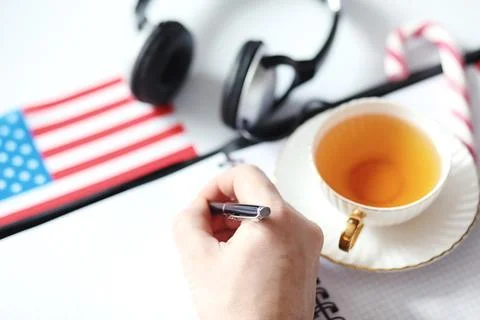 Learning foreign languages. Notepad for entries and a flag. Language course.. Stock Photos