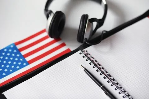 Learning foreign languages. Notepad for entries and a flag. Language course.. Stock Photos