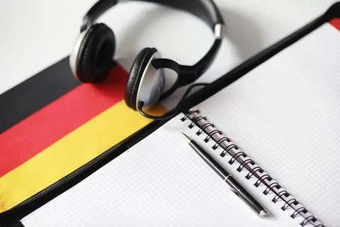 Learning foreign languages. Notepad for entries and a flag. Language course.. Stock Photos