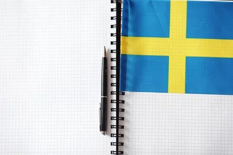 Learning foreign languages. Notepad for entries and a flag. Language course.. Stock Photos