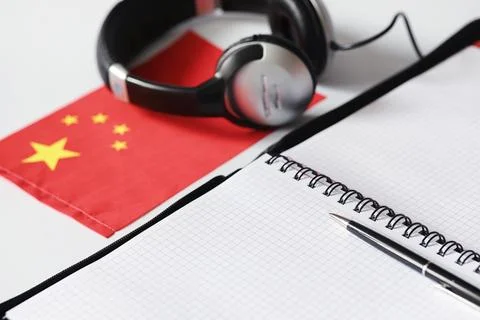 Learning foreign languages. Notepad for entries and a flag. Language course.. Stock Photos