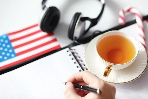 Learning foreign languages. Notepad for entries and a flag. Language course.. Stock Photos