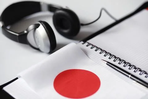 Learning foreign languages. Notepad for entries and a flag. Language course.. Stock Photos