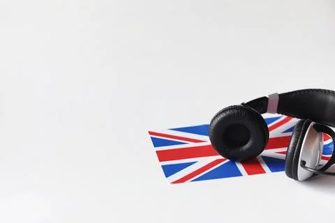 Learning foreign languages. Notepad for entries and a flag. Language course.. Stock Photos