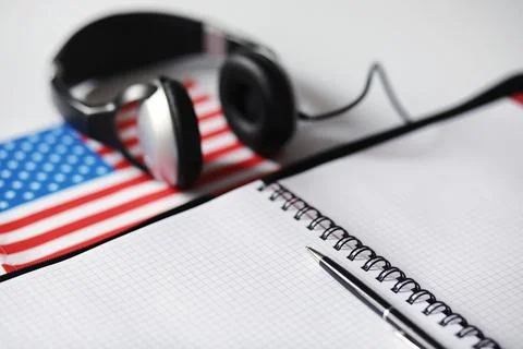 Learning foreign languages. Notepad for entries and a flag. Language course.. Stock Photos