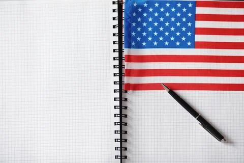 Learning foreign languages. Notepad for entries and a flag. Language course.. Stock Photos
