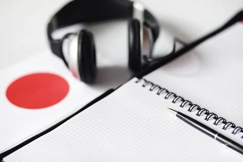 Learning foreign languages. Notepad for entries and a flag. Language course.. Stock Photos