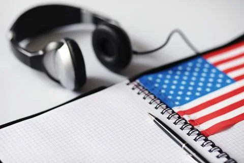 Learning foreign languages. Notepad for entries and a flag. Language course.. Stock Photos