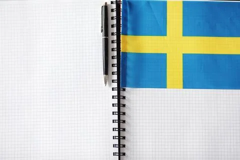 Learning foreign languages. Notepad for entries and a flag. Language course.. Stock Photos