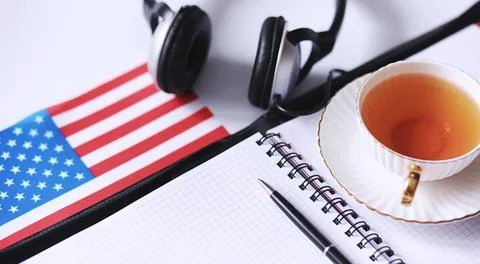 Learning foreign languages. Notepad for entries and a flag. Language course.. Stock Photos