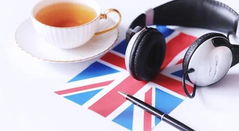 Learning foreign languages. Notepad for entries and a flag. Language course.. Stock Photos