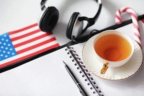 Learning foreign languages. Notepad for entries and a flag. Language course.. Stock Photos