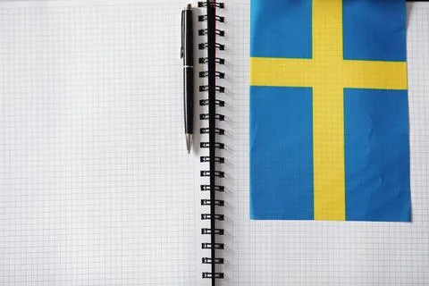 Learning foreign languages. Notepad for entries and a flag. Language course.. Stock Photos