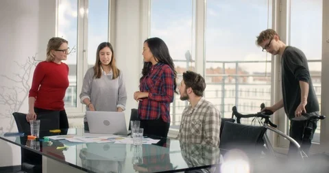 Learning group of students high fiving each other behind a glas desk Stock Footage 92012233