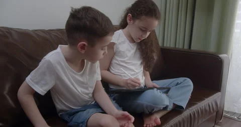 Learning how to draw on the tablet screen with a touch pen with homework Stock Footage 246362445