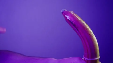 Learning how to properly use condoms and lubricants on a banana. Close up Stock Footage 308330384