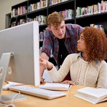 Learning, library and students on computer for help on exam knowledge, education Stock Photos