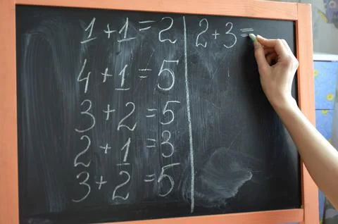 Learning math at home on a small blackboard Stock Photos