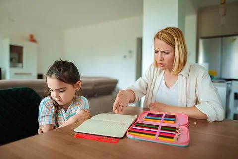 Learning moment between mother and daughter at home Stock Photos