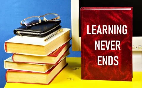 Learning never ends. Text label on the textbook. Stock Photos
