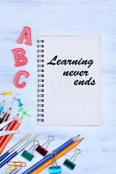 Learning never ends. Text on notebook on a desk Stock Photos