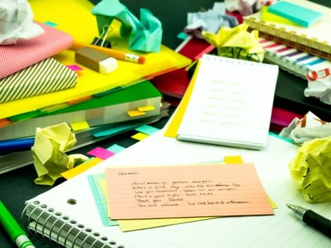 Learning New Language Writing Words Many Times on the Notebook; German Stock Photos