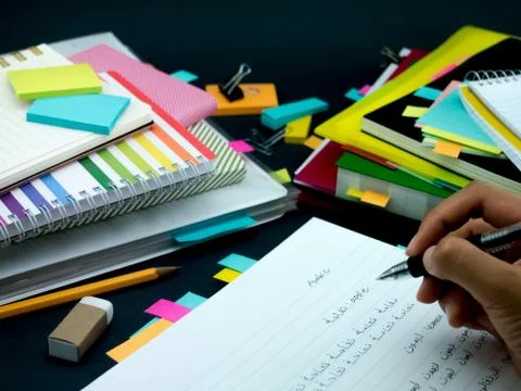 Learning New Language Writing Words Many Times on the Notebook; Arabic Stock Photos