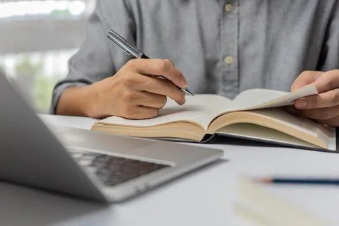 Learning online class by using laptop computer and writing notebook at work.. Foto stock