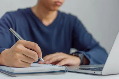 Learning online class by using laptop computer and writing notebook at work.. 스톡 사진