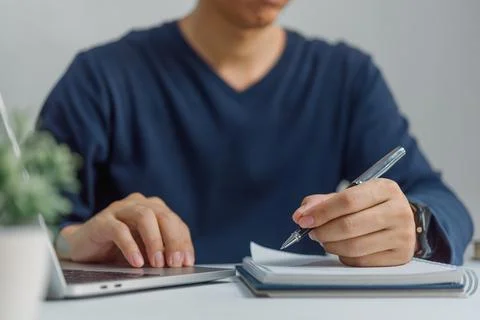 Learning online class by using laptop computer and writing notebook at work.. 스톡 사진
