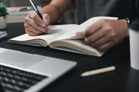 Learning online class by using laptop computer and writing notebook at work.. Foto stock