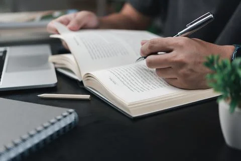 Learning online class by using laptop computer and writing notebook at work.. 스톡 사진