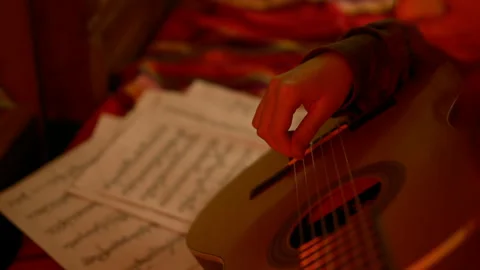 Learning to play guitar, music notes, detail guitar. Cinematic. Stock Footage 262143799