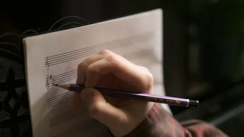 Learning to play piano. makes notes Stock Footage 302302562