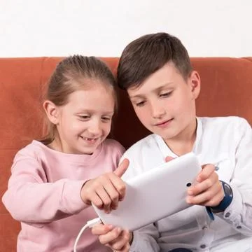 Learning to play on the tablet Stock Photos