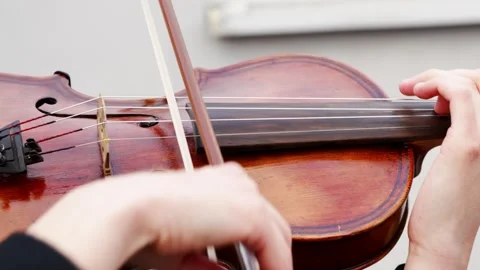 Learning to play the violin with close up shots of hands on strings and bowing Stock Footage 332054185