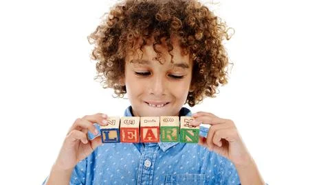 Learning in progress. Studio shot of a cute little boy holding building blocks Stock Photos