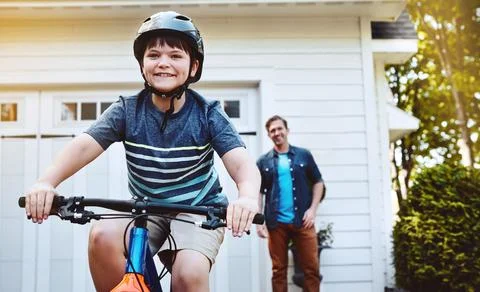 Learning to ride a bicycle is one of lifes milestones. a young boy riding a Stock Photos