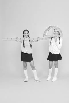 Learning school geometry. School children with measuring instruments on yellow Stock Photos