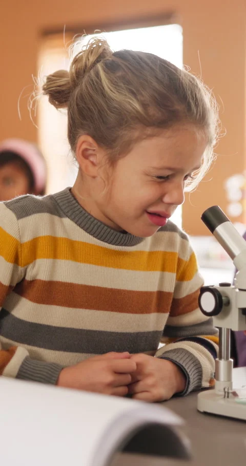 Learning, science and kid with microscope in class for development, knowledge or Stock Footage 335942680