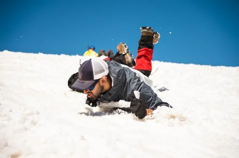 Learning to slip properly on a slope or glacier with an ice ax Stock Photos