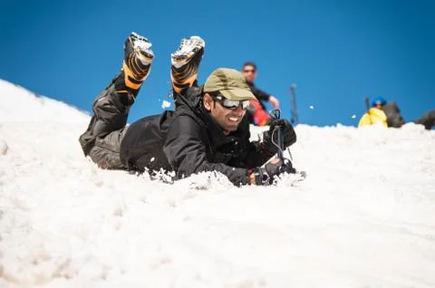 Learning to slip properly on a slope or glacier with an ice ax Stock Photos