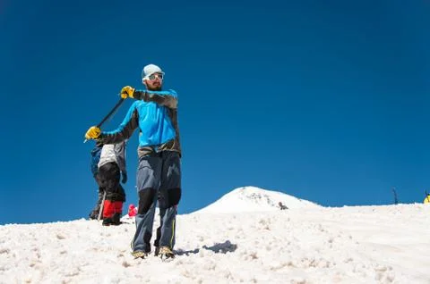 Learning to slip properly on a slope or glacier with an ice ax Stock Photos