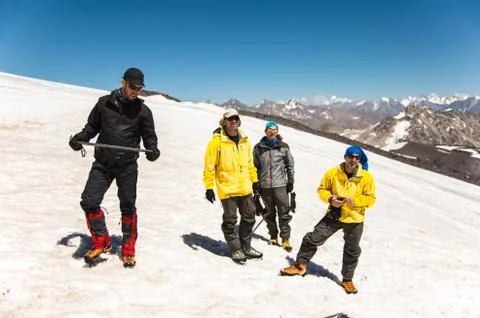 Learning to slip properly on a slope or glacier with an ice ax Stock Photos