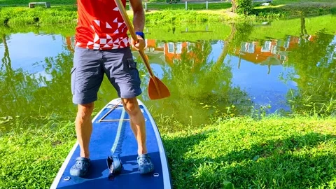 Learning to stand and paddle on a board Stock Footage 277163774